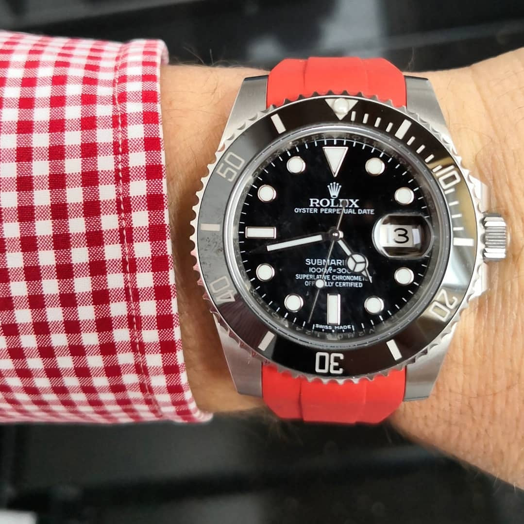 Rolex Submariner with Red Strap on wrist