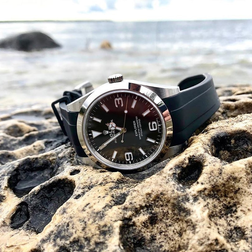 Rolex Explorer with black rubber strap on rock